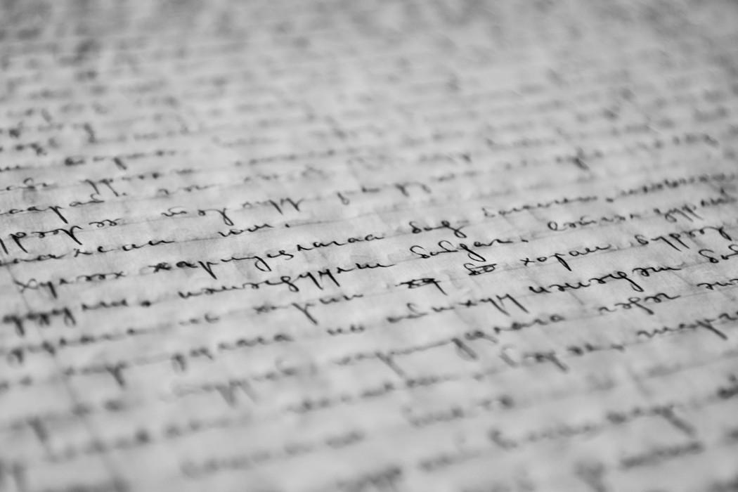 Black and white illustration of a handwritten text on a piece of paper.