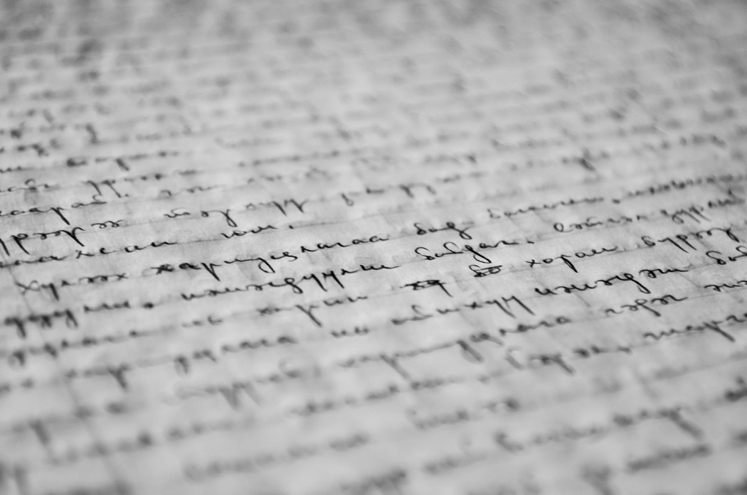 Black and white illustration of a handwritten text on a piece of paper.